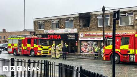 Man arrested after seven saved from fire at flats